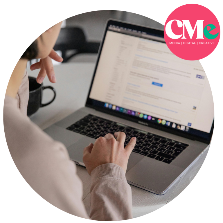 Laptop open and a lady reading content on the device