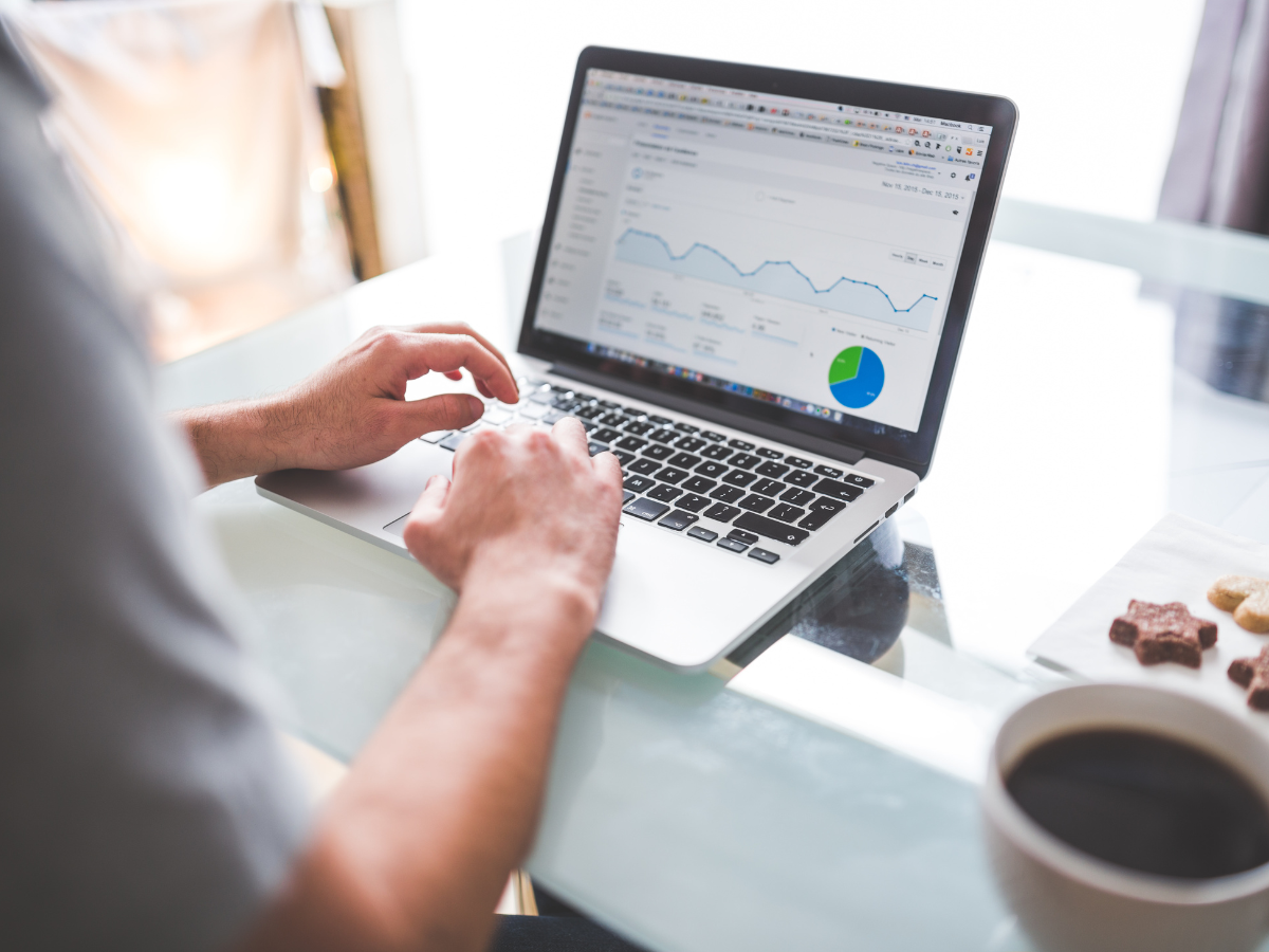 Laptop with statistics open and a person working