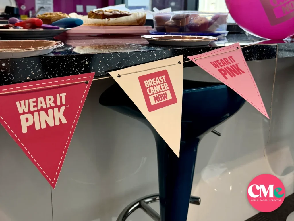 Wear It Pink bunting and a Breast Cancer Now balloon at the CMe Media bake sale