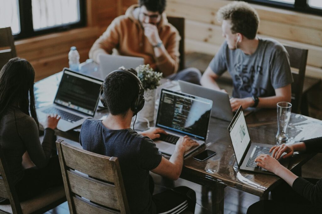 Team of writers and designers working together on laptops
