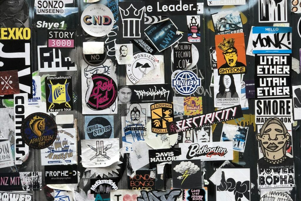 Assorted poster artwork and design layouts on a wall