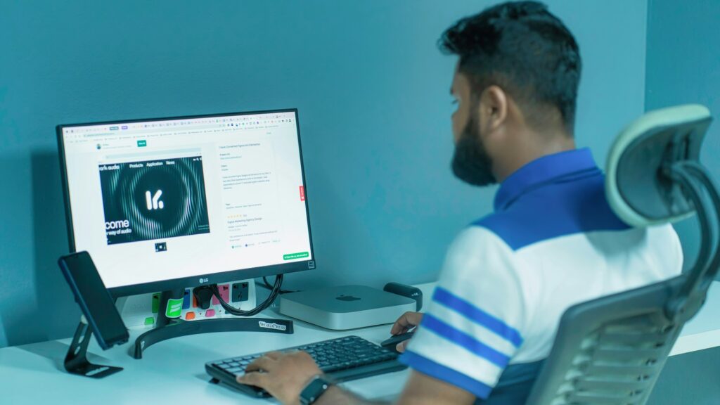 Designer working at a computer screen in a creative studio