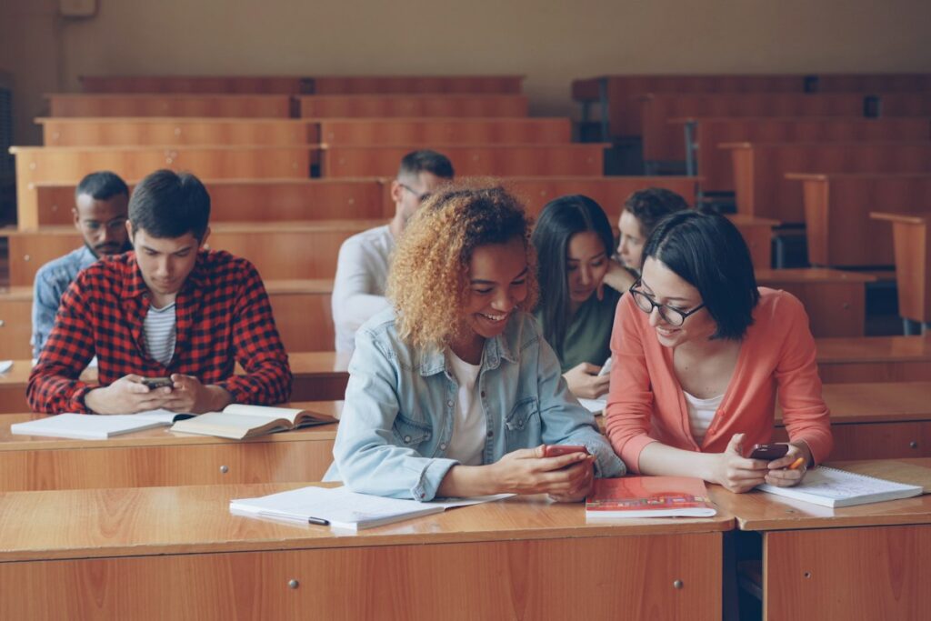 Students looking at their smartphones in a lecture hall