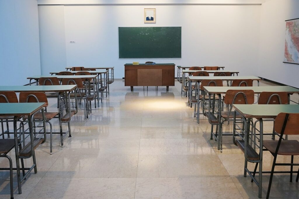 School classroom with rows of desks and a chalkboard