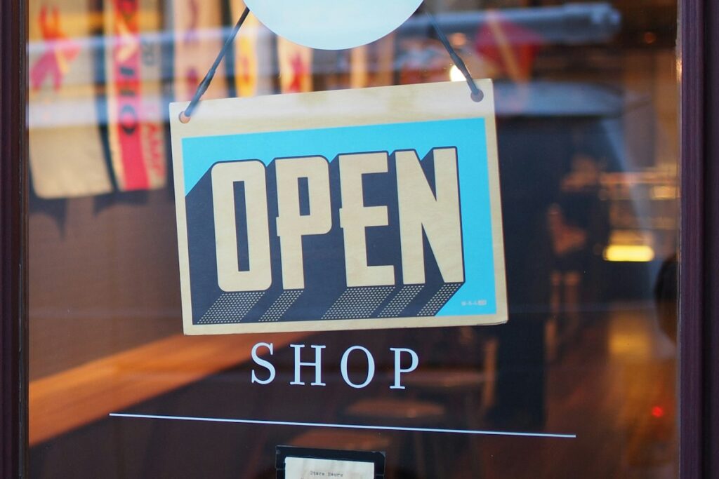Open sign hanging in a shop window, representing brand protection