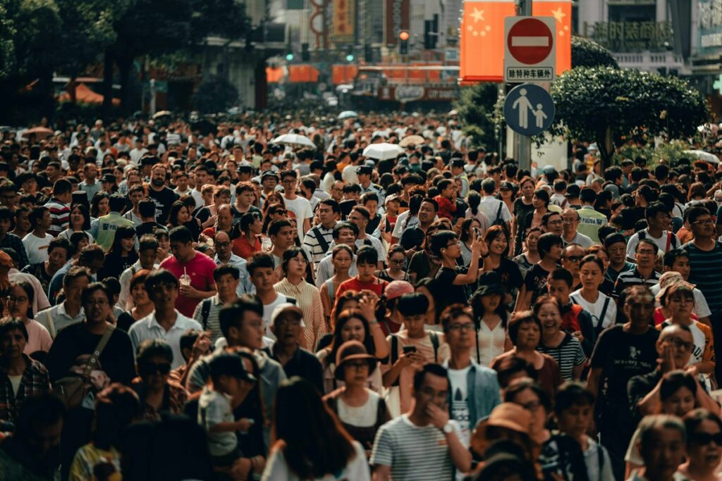 Crowd of people walking along a busy city street, representing audience targeting