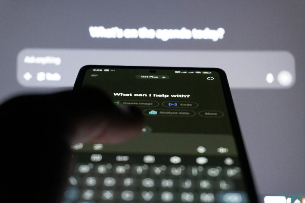 Person typing on a smartphone showing an AI chatbot assistant interface
