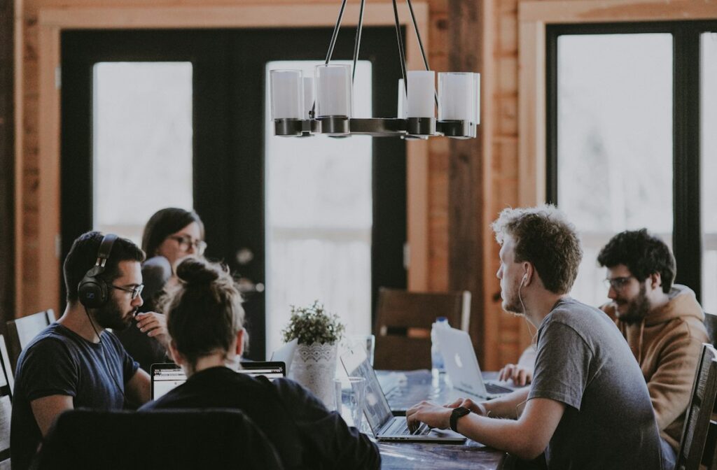 Friendly agency team collaborating around a table in a bright office