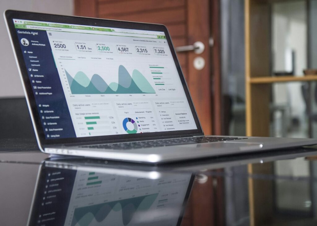 Laptop showing an advertising analytics dashboard with charts