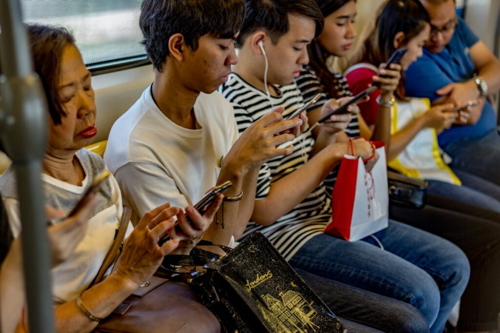 People scrolling social media feeds on their smartphones