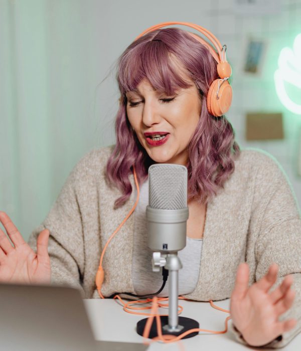 A lady talking into a table top microphone